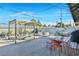 This backyard features a pergola with comfortable seating, a hammock, a hot tub, gravel and desert landscaping at 105 Shadow Ln, Las Vegas, NV 89106