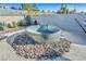 Backyard features a unique stock tank pool surrounded by decorative rocks, creating a relaxing and visually appealing outdoor oasis at 105 Shadow Ln, Las Vegas, NV 89106