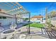 Backyard patio featuring a pergola, outdoor seating, dining area, and fire pit, creating a cozy and inviting entertainment space at 105 Shadow Ln, Las Vegas, NV 89106
