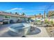 Spacious backyard includes a lounging area, hot tub, desert landscaping, a pergola, a grill, and outdoor dining at 105 Shadow Ln, Las Vegas, NV 89106