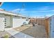 Backyard with decorative string lights, desert landscaping, modern horizontal wood slat fence, and a fire pit at 105 Shadow Ln, Las Vegas, NV 89106
