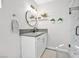 A modern bathroom vanity with plants, vanity lights, and a marble shower at 105 Shadow Ln, Las Vegas, NV 89106
