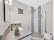 Modern bathroom showcasing a shower with gray and white tiles, a sleek vanity, and contemporary fixtures at 105 Shadow Ln, Las Vegas, NV 89106