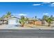 Charming single-story home featuring a well-maintained lawn with mature palm trees and an attached two-car garage at 105 Shadow Ln, Las Vegas, NV 89106