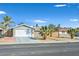Charming single-story home featuring a well-maintained lawn with mature palm trees and an attached two-car garage at 105 Shadow Ln, Las Vegas, NV 89106