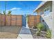 Attractive front yard with desert landscaping, modern horizontal wood slat fence, and decorative string lights at 105 Shadow Ln, Las Vegas, NV 89106
