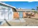 Attractive front yard with desert landscaping and a modern, horizontal wood slat fence and entry gate at 105 Shadow Ln, Las Vegas, NV 89106