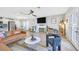 A stylish open-concept living room with a fireplace, ceiling fan, and recessed lights at 105 Shadow Ln, Las Vegas, NV 89106