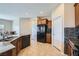 Bright kitchen featuring tile floors, granite countertops and a modern black refrigerator at 10693 Harvest Green Way, Las Vegas, NV 89135