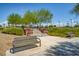 Inviting park benches and walkway surrounded by lush landscaping and steps leading to a basketball court at 10693 Harvest Green Way, Las Vegas, NV 89135