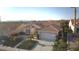 Exterior aerial view of a home with a tile roof, two-car garage, and landscaped yard at 10717 Grand Cypress Ave, Las Vegas, NV 89134