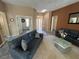 Neutral living area features two sofas with a tile and carpet flooring at 10717 Grand Cypress Ave, Las Vegas, NV 89134
