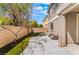Spacious backyard featuring a block wall, artificial grass, and a concrete patio at 11901 Luna Del Mar Ln, Las Vegas, NV 89138