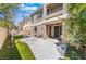 Picturesque backyard featuring artificial grass, a patio, and lush landscaping at 11901 Luna Del Mar Ln, Las Vegas, NV 89138