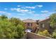 A backyard with a view of neighboring homes and lush green trees at 11901 Luna Del Mar Ln, Las Vegas, NV 89138