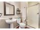 Cozy bathroom featuring a pedestal sink, ornate mirror, and a tiled walk-in shower at 11901 Luna Del Mar Ln, Las Vegas, NV 89138