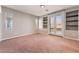 Open bedroom with a carpeted floor, light gray walls, and recessed built-in shelving at 11901 Luna Del Mar Ln, Las Vegas, NV 89138