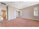 Spacious bedroom with a carpeted floor, and a view into the connected hallway and closet at 11901 Luna Del Mar Ln, Las Vegas, NV 89138