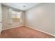 Bedroom with neutral carpet and a window at 11901 Luna Del Mar Ln, Las Vegas, NV 89138