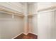 Walk-in closet with neutral carpet, shelving, and wooden bars for hanging clothes at 11901 Luna Del Mar Ln, Las Vegas, NV 89138