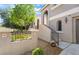 Exterior of the home showcasing a tiled wall, wrought iron fence, and desert landscaping at 11901 Luna Del Mar Ln, Las Vegas, NV 89138