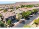 Inviting two-story home featuring a private driveway and mature trees providing ample shade and curb appeal at 11901 Luna Del Mar Ln, Las Vegas, NV 89138
