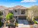 Two-story home featuring a tile roof, gray stucco exterior, and a two car garage at 11901 Luna Del Mar Ln, Las Vegas, NV 89138