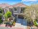 Charming two-story home with a tile roof, manicured landscaping, and an inviting entrance at 11901 Luna Del Mar Ln, Las Vegas, NV 89138