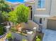 Inviting front entrance with an arched doorway, decorative tiles, and landscaped garden area at 11901 Luna Del Mar Ln, Las Vegas, NV 89138
