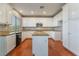 Well-lit kitchen with white cabinets, granite countertops, and a central island at 11901 Luna Del Mar Ln, Las Vegas, NV 89138