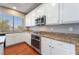Updated kitchen featuring granite countertops, stainless appliances, and bright white cabinetry at 11901 Luna Del Mar Ln, Las Vegas, NV 89138
