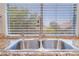 Close-up of a stainless steel kitchen sink with granite countertops and a window view at 11901 Luna Del Mar Ln, Las Vegas, NV 89138