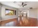 Open-concept living room with hardwood floors flowing into a bright kitchen area at 11901 Luna Del Mar Ln, Las Vegas, NV 89138
