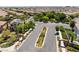 Inviting neighborhood street with landscaped medians, mature trees, and attractive entrance features at 11901 Luna Del Mar Ln, Las Vegas, NV 89138