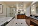Bright bathroom boasts a walk-in shower, soaker tub, and double-sink vanity at 135 E Harmon Ave # 2821, Las Vegas, NV 89109