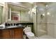 Bathroom featuring a glass shower, granite vanity, and framed mirror at 135 E Harmon Ave # 2821, Las Vegas, NV 89109