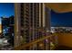 Night view of high rise building featuring the cityscape reflecting in the windows at 135 E Harmon Ave # 2821, Las Vegas, NV 89109