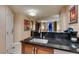 Kitchenette with a breakfast bar that opens to a living area with a view at 135 E Harmon Ave # 2821, Las Vegas, NV 89109