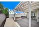 Backyard view of a covered patio, enclosed by a block wall and featuring a concrete base at 1950 Turtlerock St, Las Vegas, NV 89142
