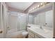 Well-lit bathroom featuring a shower-tub combo and tiled vanity at 1950 Turtlerock St, Las Vegas, NV 89142