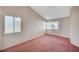 Cozy bedroom featuring plush carpet, large windows, and ample natural light at 1950 Turtlerock St, Las Vegas, NV 89142