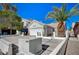 Nice single-story home with a two-car garage, spacious driveway, mature trees, and low-maintenance desert landscaping at 1950 Turtlerock St, Las Vegas, NV 89142