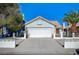 Charming single-story home with a two-car garage and a well-maintained front yard with mature trees at 1950 Turtlerock St, Las Vegas, NV 89142
