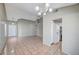Inviting living room features neutral paint, vaulted ceilings, tile floors, open layout and access to the kitchen at 1950 Turtlerock St, Las Vegas, NV 89142