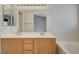 Bathroom vanity with dual sinks, large mirror, and a view into the bedroom at 1981 Spring Lake Dr, Henderson, NV 89002