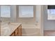 Bathroom with a tub, sink vanity with drawers, and a window with blinds at 1981 Spring Lake Dr, Henderson, NV 89002