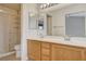 Bathroom featuring a dual sink vanity, mirrors, and a shower with glass doors at 1981 Spring Lake Dr, Henderson, NV 89002