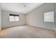 Spacious bedroom with neutral carpet, vaulted ceiling, ceiling fan, and dual windows at 1981 Spring Lake Dr, Henderson, NV 89002