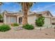 Single-story home with a two-car garage, desert landscaping, and solar panels, offering curb appeal at 1981 Spring Lake Dr, Henderson, NV 89002
