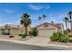 Single-story house with a two-car garage, desert landscaping, and solar panels on the roof at 1981 Spring Lake Dr, Henderson, NV 89002